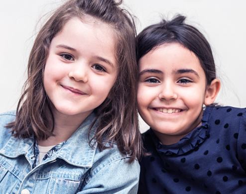 Two girls are smiling at the private bilingual international school of Paris