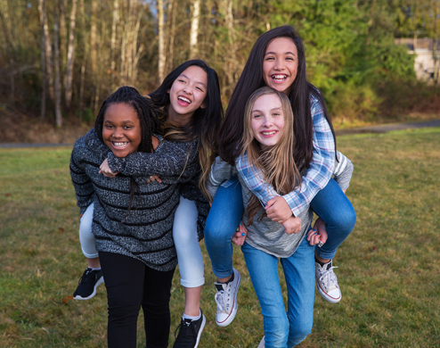 Middle school students are laughing in a field trip